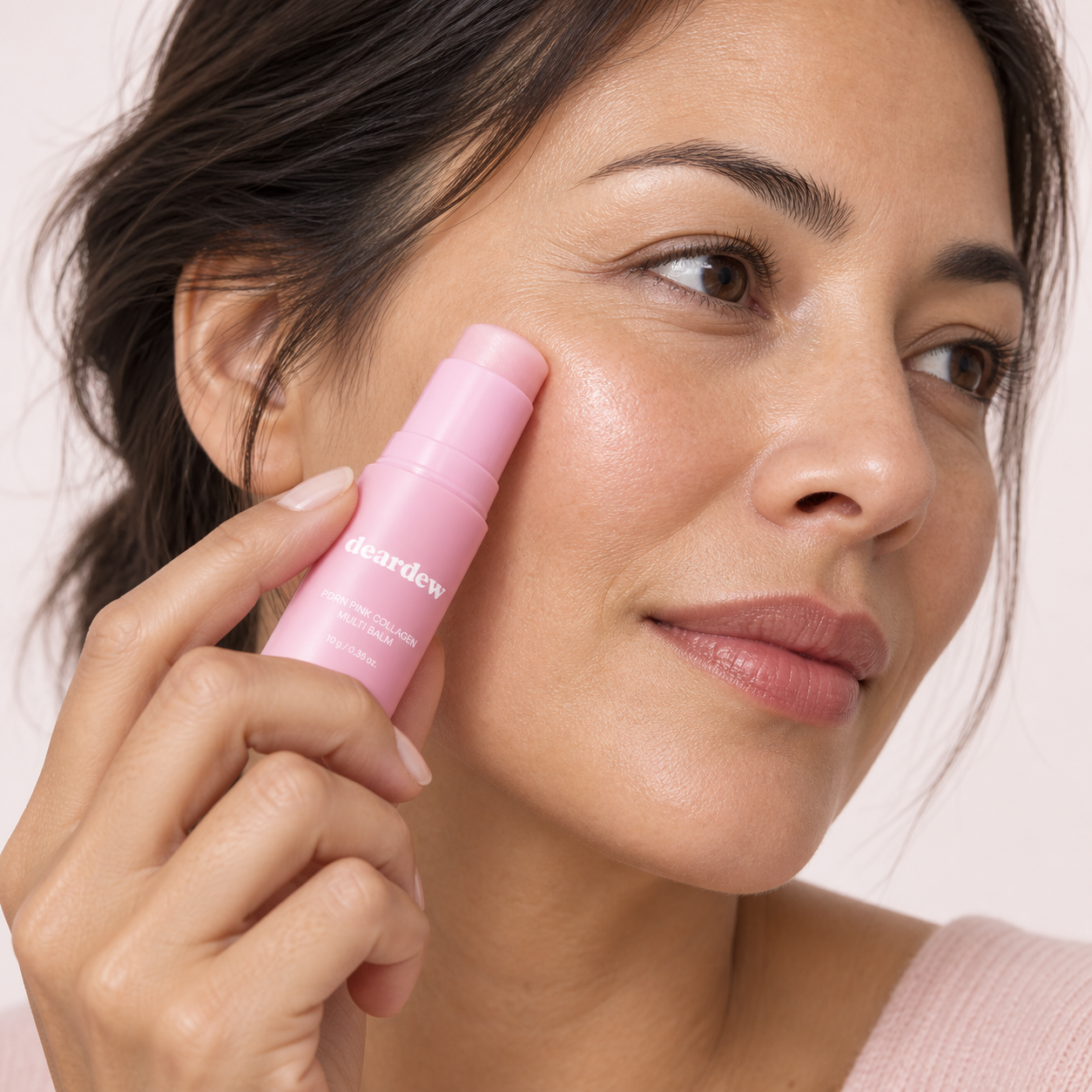 Applying DearDew balm gently to the cheek below the eye